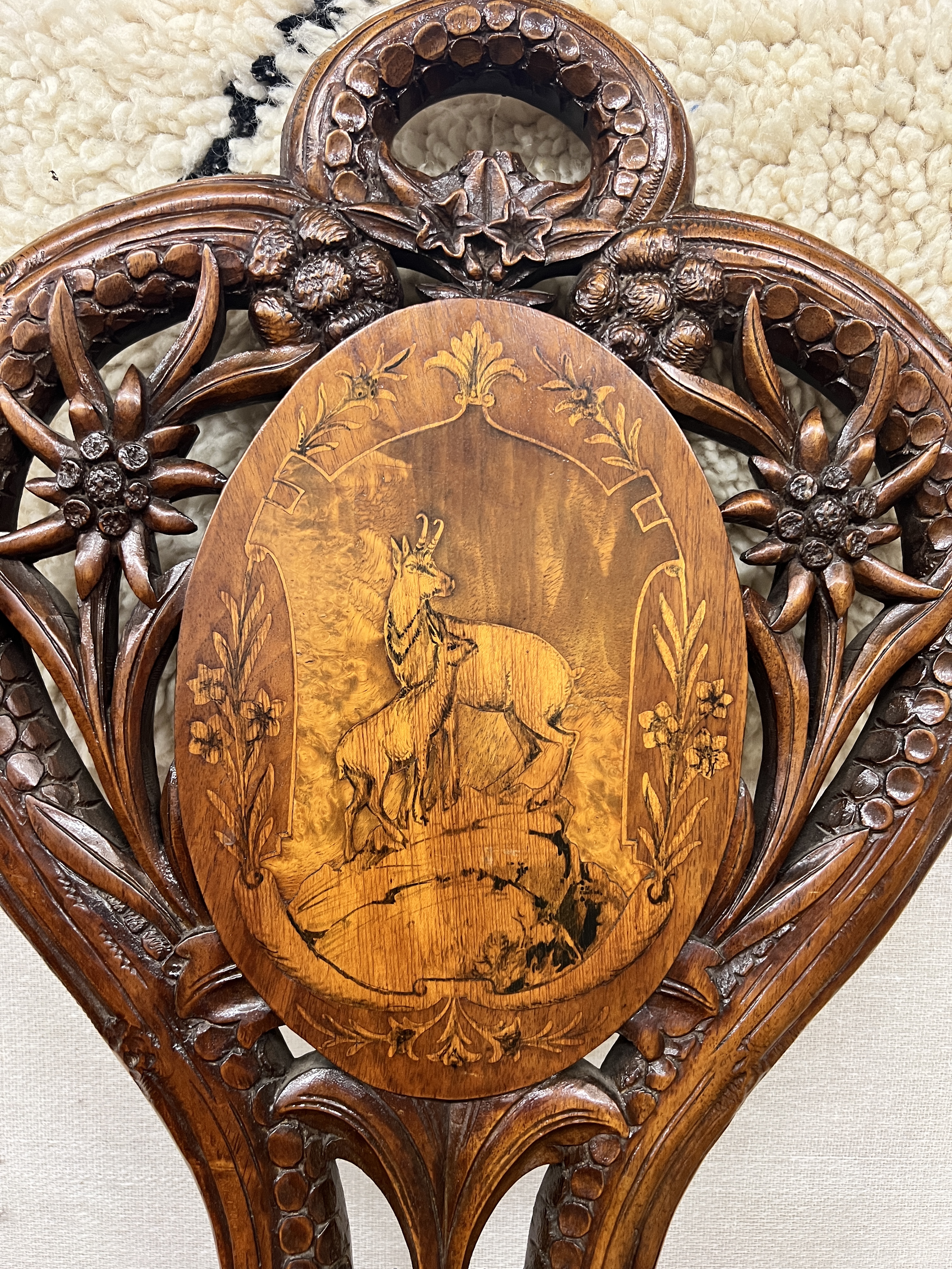 A 19th century Black Forest carved walnut musical chair decorated with panels of deer, width 45cm, depth 38cm, height 94cm
